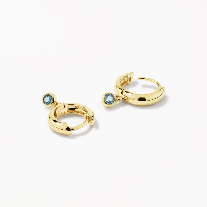 Blue Topaz Round Drop Charm Huggie Earrings in Gold