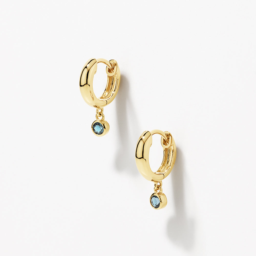 Blue Topaz Round Drop Charm Huggie Earrings in Gold