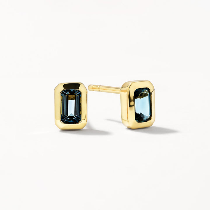 Blue Topaz Emerald Cut Stud Earrings in Gold