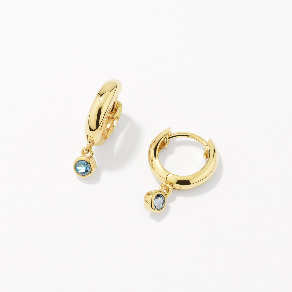 Medley Earrings Blue Topaz Round Drop Charm Huggie Earrings in Gold